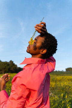 Dancer Performs in a Field With Bright Flowers in the Afternoon Sun