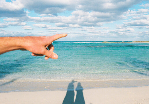 Man points out toward the ocean in the Bahamas