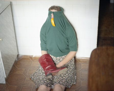 Woman sitting on the floor with a red boot