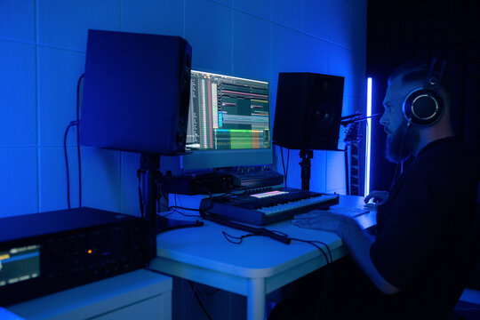 Focused man making new music track 