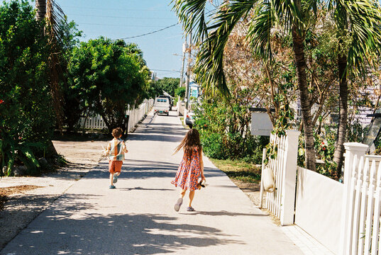 Family walks through Hope Town Settlement, Elbow Cay, Bahamas