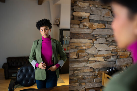 Woman adjusts her outfit in a cozy room