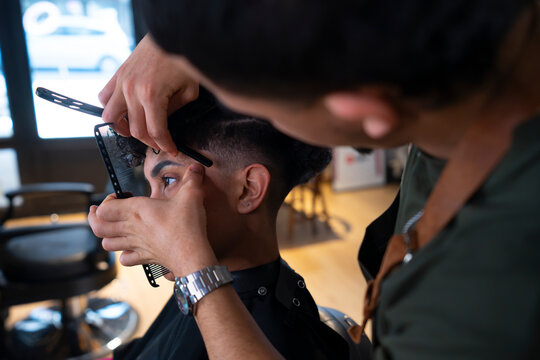 Client receives haircut and grooming at barbershop