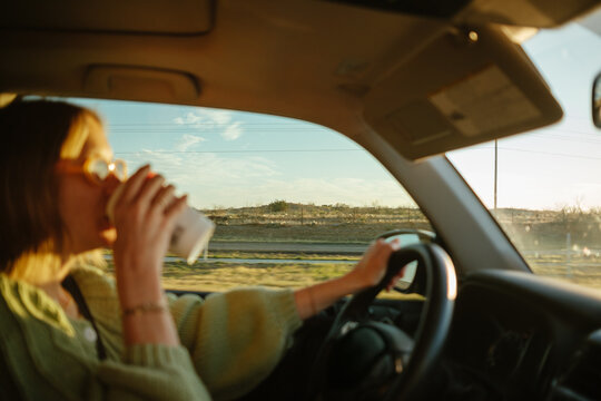 Woman Drinking Coffee In Car