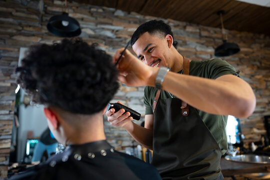Barber cuts hair in modern salon setting