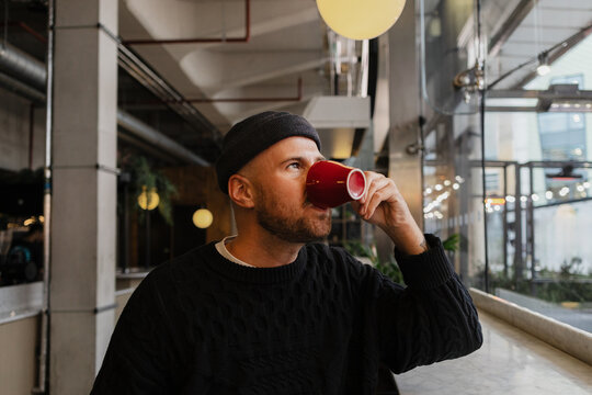Man enjoying coffee in cafe creating urban lifestyle