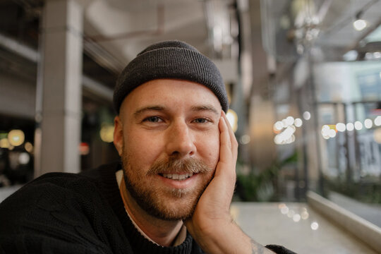 Man wearing beanie smiling looking directly at camera