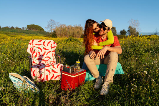 Couple kiss Enjoys Picnic in a Field 