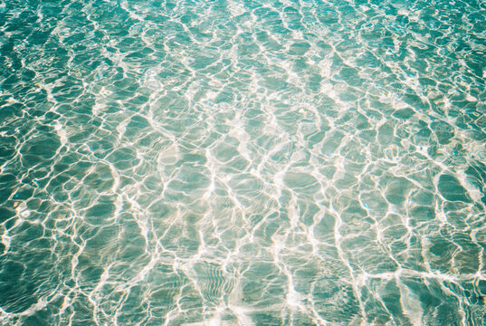 Abstract pattern of ripples on surface of shallow water on beach