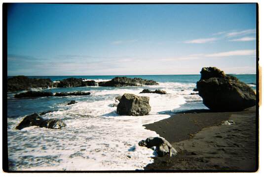 Waves Crash on Rocks at the Shore During a Sunny Day in TENERIFE