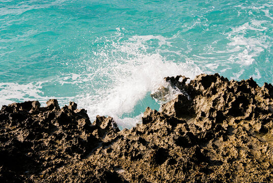 Abstract rock formation and blue green water in the Bahamas