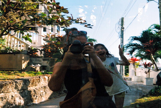 Mother and daughter selfie portrait in car window reflection 