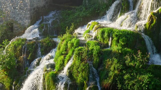 Slow motion shot of Flowing River Waterfall in Rastoke Village.