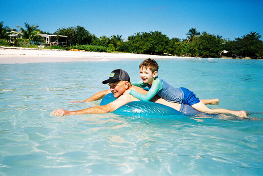 Happy Family on Vacation Swim Together in Caribbean Sea