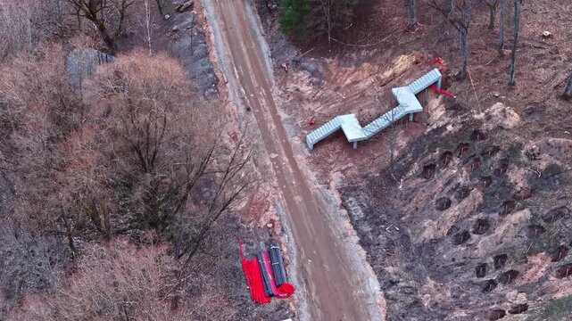 Aerial view of a pipeline construction site with new stairs in a deforested area
