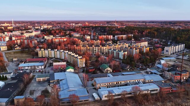 Beautiful sunset casting long shadows and warm light over an old industrial area and city