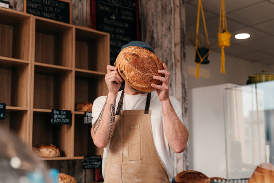 Portrait of Baker Holding Bread in Bakery 