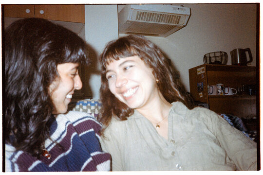 Same sex couple laughing in indoors