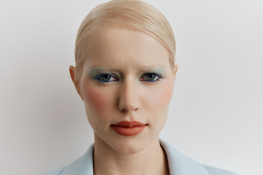 Beauty portrait serious blonde woman with colorful makeup 