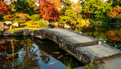Naklejka premium Beautiful stone bridge in serene garden setting.