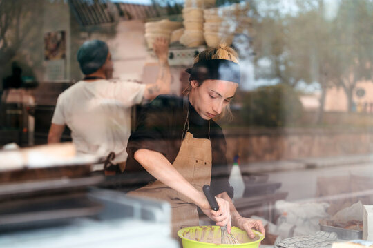 Bakery Worker Prepares Dough in Shop During