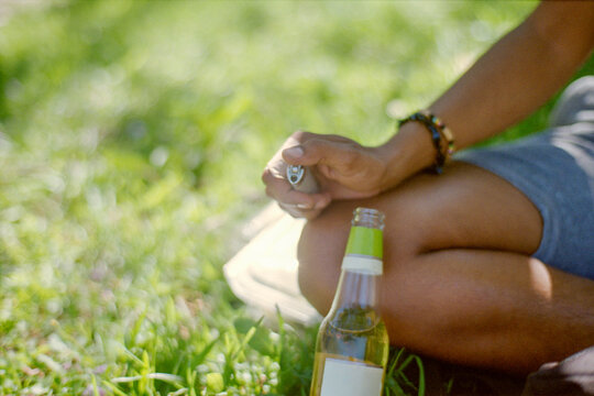 Lighter Beside Beer Bottle