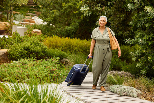 Woman with suitcase arriving at the luxury rental house