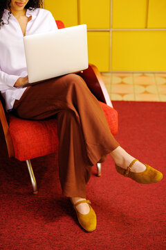 Business Lifestyle Woman on Laptop in Red Chair