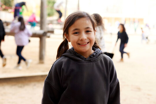 Happy Child Smiles in Playground