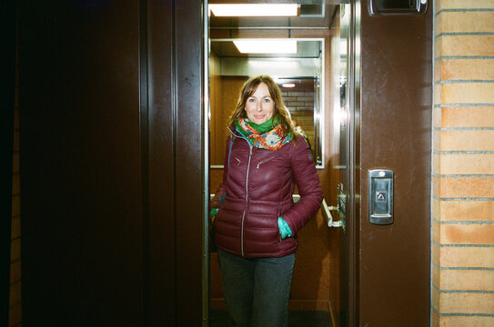 Woman Standing in Elevator with Open Door