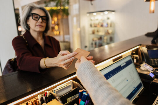 Guest receiving key card for hotel stay