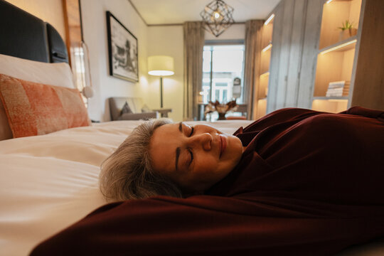 Sleeping comfortably in luxury hotel bedroom enjoying peaceful rest