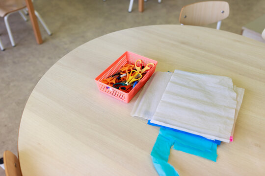 Craft Supplies on a Round Table in a Classroom Setting