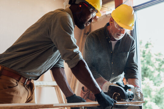Construction Workers with Circular Saw