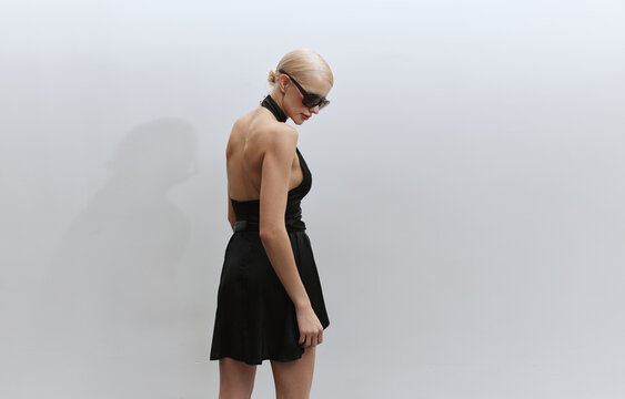 Elegant fashion portrait woman in black dress and sunglasses