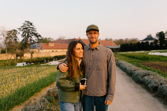 Smiling couple posing in the grounds of a countryside hotel