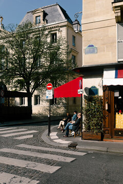 A wide shot of a local caf&eacute; at a street corner in Paris
