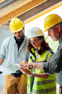 Construction Workers Brainstorming with Architect