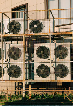 Air Conditioning Units Set Against Building Wall in Urban Area