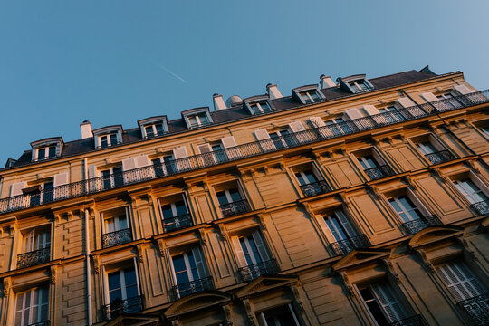 Traditional building facade in Paris, France, illuminated by the sun
