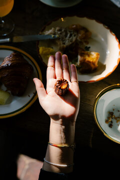 Unidentified woman&rsquo;s hand holding a traditional French dessert