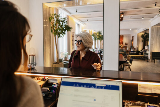 Guest checking in at luxury hotel reception desk