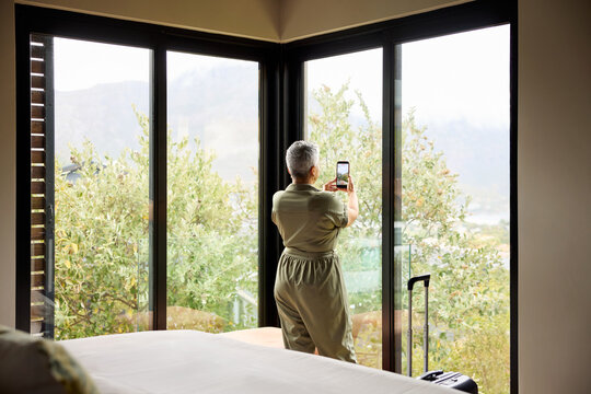 Woman Takes Picture From a Cabin.