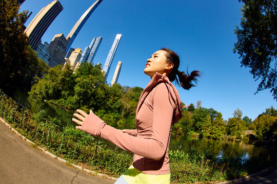 Woman performs running exercise in Central Park, NYC