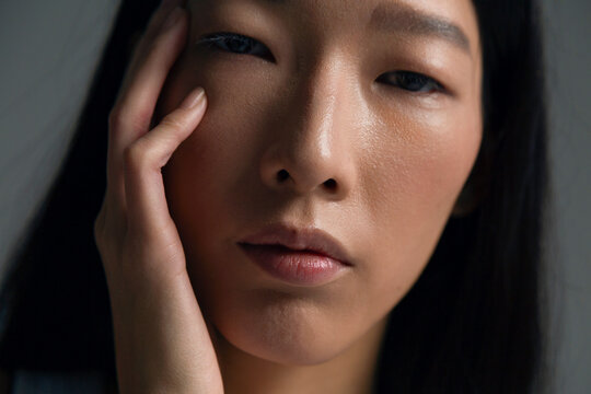 Person showing hand on face with subtle expression