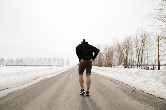 Back view runner o winter road