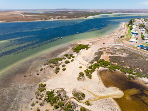 Wetlands and waterholes along a coastline near a shoreline village
