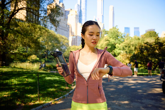 Sportswoman checks the pace on her watch in Central Park