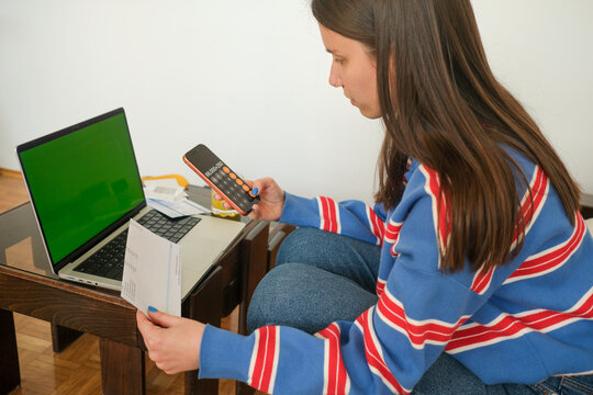 Managing finances or data with calculator and laptop