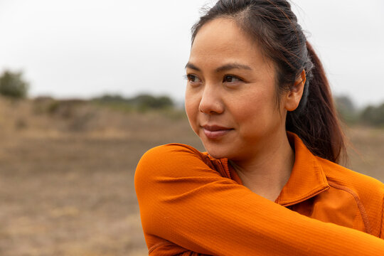 Confident Asian woman stretch athlete runner 